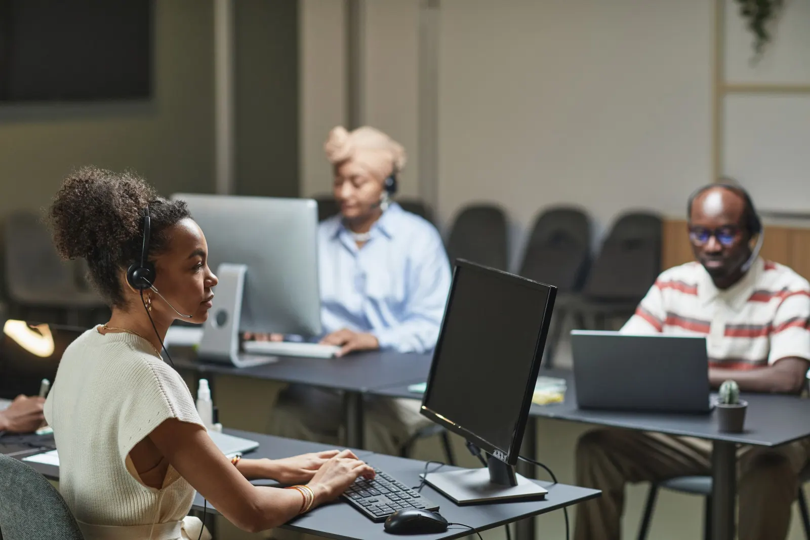 Agents on headsets working at their desks