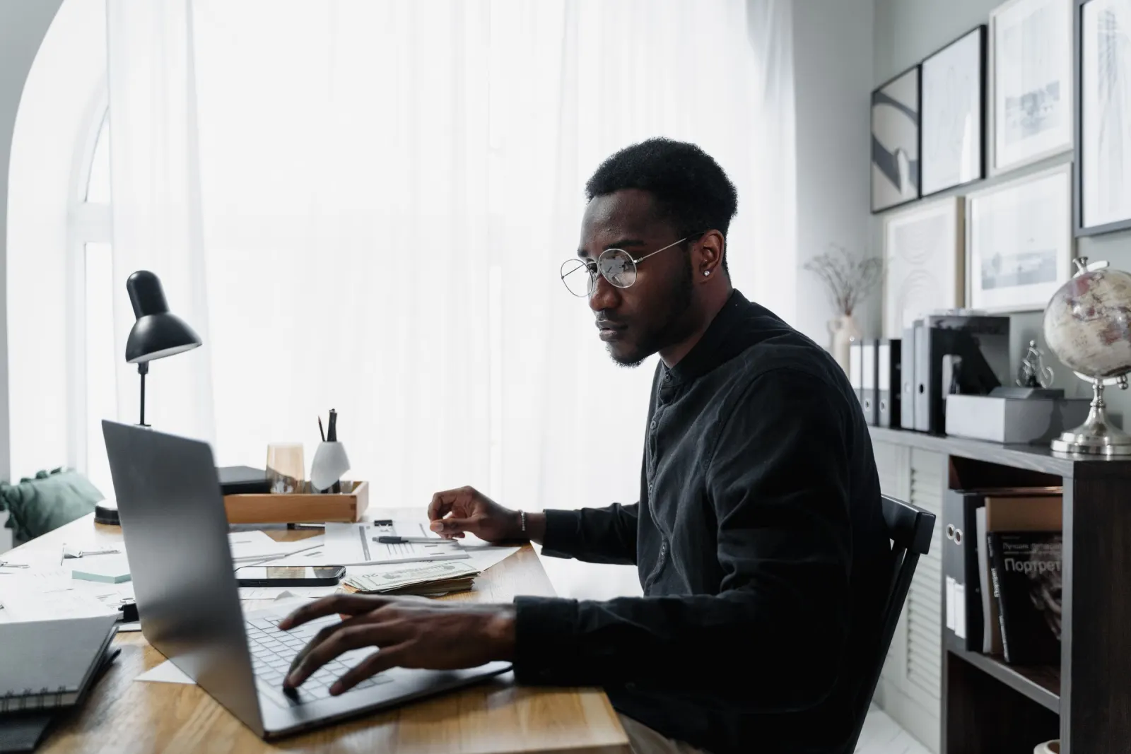 Person working through a CRM on a laptop at a desk