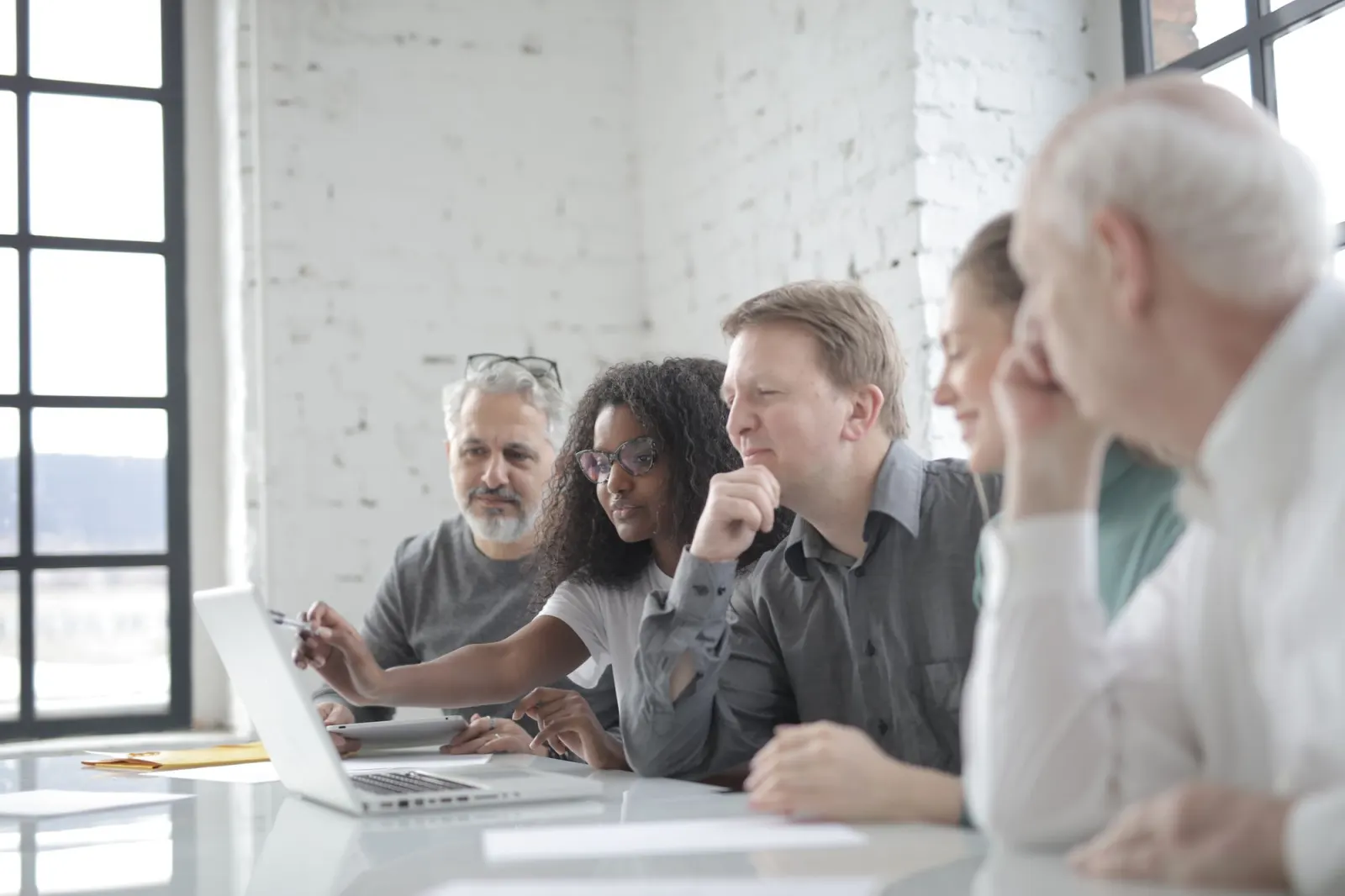 Team discussing a project around a laptop