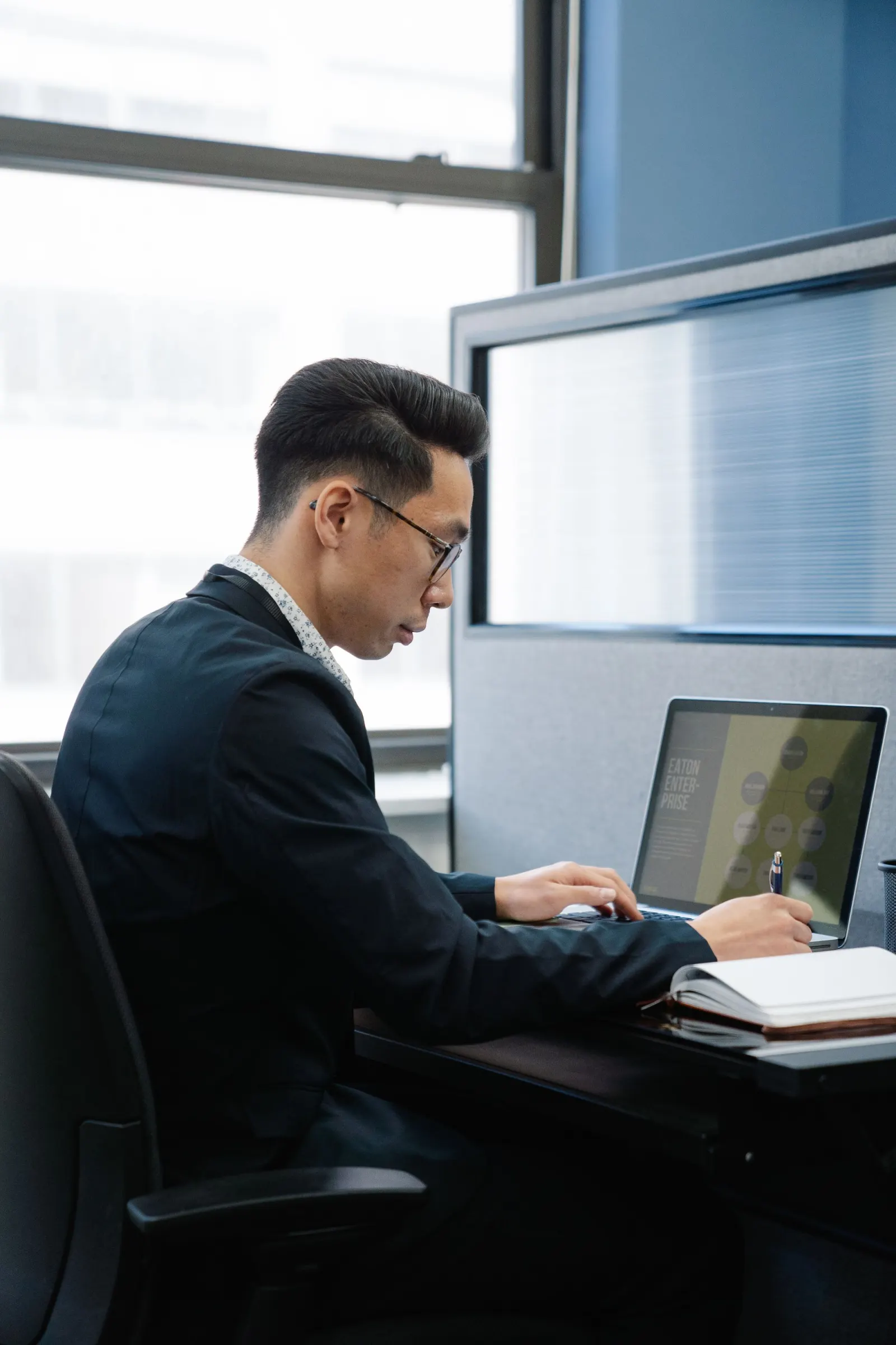 Person working on a laptop in an office